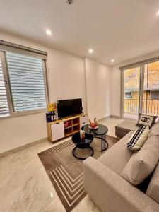 a living room with a couch and a tv at Lumina Haven in Thượng Lôi