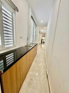 a kitchen with a counter and a sink and windows at Lumina Haven in Thượng Lôi