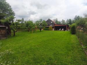 a large yard with a house in the background at Chata Vanessa in Stránske +11 photos