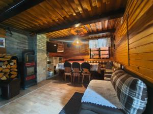 a living room with a couch and a table and a fireplace at Chata Vanessa in Stránske
