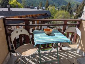 a table and chairs on a balcony with a view at Bright and silent studio in Bardonecchia centre in Bardonecchia