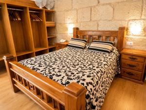 a bedroom with a bed with a black and white comforter at Hotel Boa Vila in Pontevedra