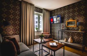 a living room with a couch and a table at Corner Hotel in Stockholm