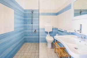 a bathroom with a toilet and a sink and a shower at Giostemar Rooms - Playa Grande in Scicli +77 photos