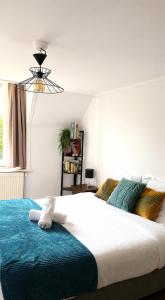 a bedroom with a large bed with a blue blanket at LE MATIN CALME - Charme ancien - Vue canal in Dole