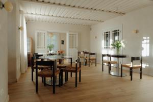 a dining room with black tables and chairs at Ausma Hotel in Kuldīga