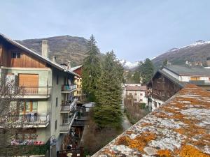 a group of buildings in a town with snow at Bright and silent studio in Bardonecchia centre in Bardonecchia +9 photos