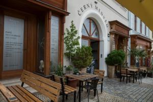 a restaurant with benches and tables outside of a building at Rezidence Černý medvěd in Znojmo