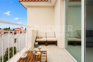 a balcony with a table and a couch on it at Apartment El Breeze in Paralimni +7 photos