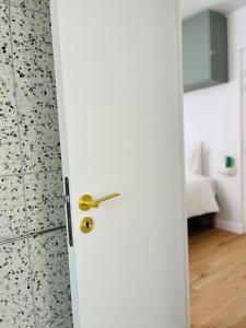 an open door with a bathroom in the background at La Maison Kerguelen - Suite in Quimper