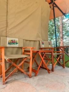 a table and a chair under a tent at Emaamara camp in Narok +2 photos