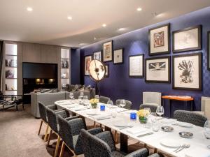 a dining room with a table and chairs at Sofitel Paris Arc De Triomphe in Paris