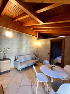 a living room with a couch and a table and chairs at BEddy & Breakfast - Station Loft in Seregno