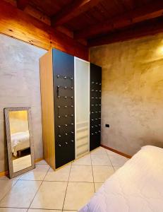a bedroom with a closet with a mirror and a bed at BEddy & Breakfast - Station Loft in Seregno +1 photo