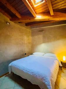 a bedroom with a white bed with a wooden ceiling at BEddy & Breakfast - Station Loft in Seregno