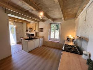 a kitchen with a stove top oven in a room at Le pavillon des sœurs in Fontenille +15 photos