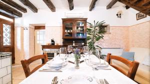 a dining room with a table and a kitchen at Villa Nostalgia - with private heated pool, jacuzzi and sauna in Koper