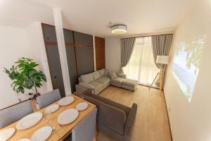 a living room with a table and a couch at Kokura Family House, 10 Min to Station, 2 Parking, 4 Bed Room in Kitakyushu