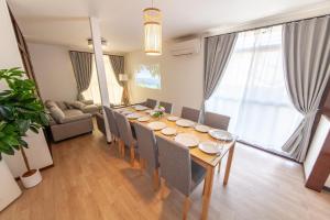 a dining room with a long table and chairs at Kokura Family House, 10 Min to Station, 2 Parking, 4 Bed Room in Kitakyushu