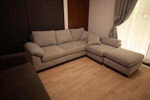 a couch in a living room with a wooden floor at Kokura Family House, 10 Min to Station, 2 Parking, 4 Bed Room in Kitakyushu +110 photos