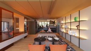 a living room with a table and orange chairs at You Hotel de France Valence - Handwritten Collection in Valence