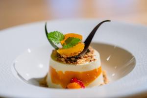 a dessert on a white plate on a table at Frich`s Hotel Surnadal in Surnadal +85 photos