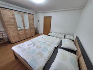a bedroom with two beds and a closet at Apartment LIKA in Gospić