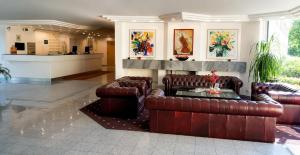 a living room with leather couches and a table at Lenas West Hotel in Vienna