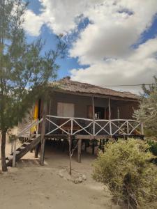 a small house with a porch and a deck at Espace baleine Anakao in Anakao