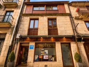 a store front of a brick building with windows at Hotel Boa Vila in Pontevedra