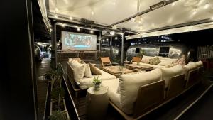 a living room with white couches and a television at Grand Daddy Boutique Hotel in Cape Town