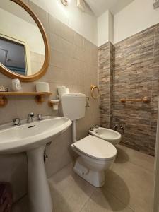 a bathroom with a toilet and a sink and a mirror at Hotel Panoramico in Corfino +100 photos