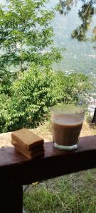 a cup of coffee and a piece of bread on a table at Dream destination in Kulu