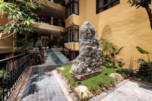 a statue of a dog in front of a building at Tam Coc Holiday Hotel & Spa in Ninh Binh