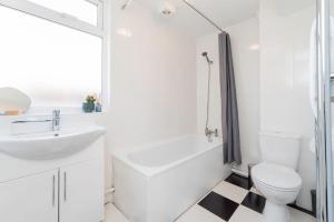 a white bathroom with a sink and a toilet at 4 Bed Contractor Apartment with Parking Central Banbury in Banbury +21 photos