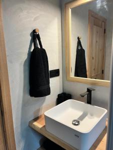 a bathroom with a white sink and a mirror at Casa do Encanto in Terra Alta +9 photos