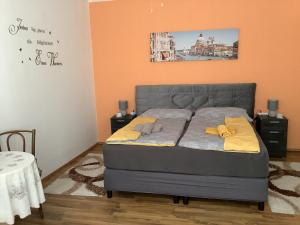 a bedroom with a bed with yellow pillows on it at Ferienwohnung Casa Flora in Pamhagen