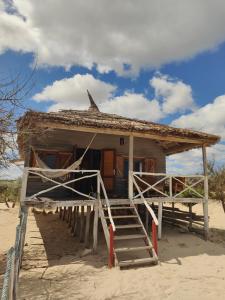a small hut on the beach with a staircase at Espace baleine Anakao in Anakao