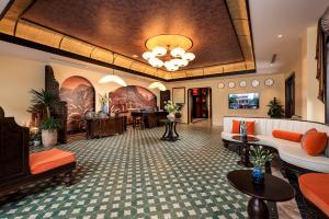 a lobby of a hotel with couches and tables at Tam Coc Holiday Hotel & Spa in Ninh Binh