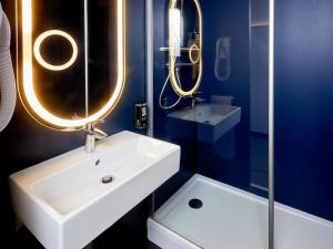 a bathroom with a white sink and a mirror at ibis Auxerre Centre in Auxerre +70 photos