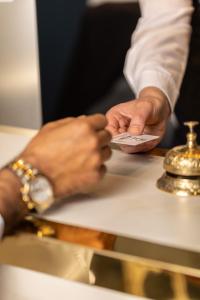 a man holding a remote control in his hands at Hotel Regina in Caserta