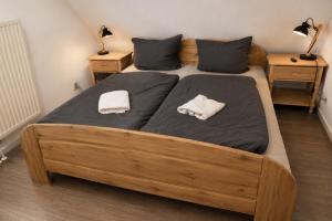 a bedroom with a large bed with two towels on it at Ferienhaus zum Kranichblick ideal für Familien gern mit Hund in Garz