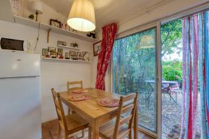 a kitchen with a table and a large window at Le Mazet Du Maréchal Ferrant in Maguelonne-la-Sauvage +42 photos