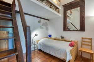 a bedroom with a bunk bed and a mirror at Le Mazet Du Maréchal Ferrant in Maguelonne-la-Sauvage