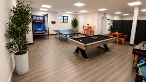 a room with a pool table and ping pong ball at Bay Ridge ApartHotel in Brooklyn