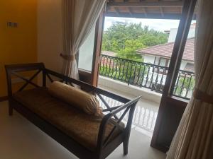 a room with a balcony with a bench and a window at Deepa Thamel House in Cotta Road Railroad Station