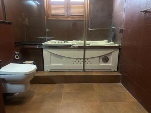 a bathroom with a toilet and a glass counter at Deepa Thamel House in Cotta Road Railroad Station