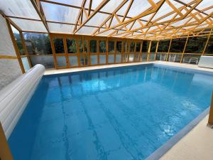 an indoor swimming pool with a roof at Landhaus Lührmann in Ramsau am Dachstein
