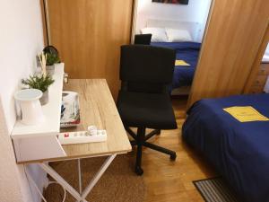 a room with a desk and a chair and a bed at Cozy Private Room -5 mins from CERN -Shared Apartment in Saint-Genis-Pouilly +3 photos