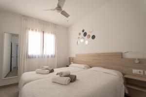 a bedroom with two beds with towels on them at V110B Villa La Pau in Son Bou +32 photos